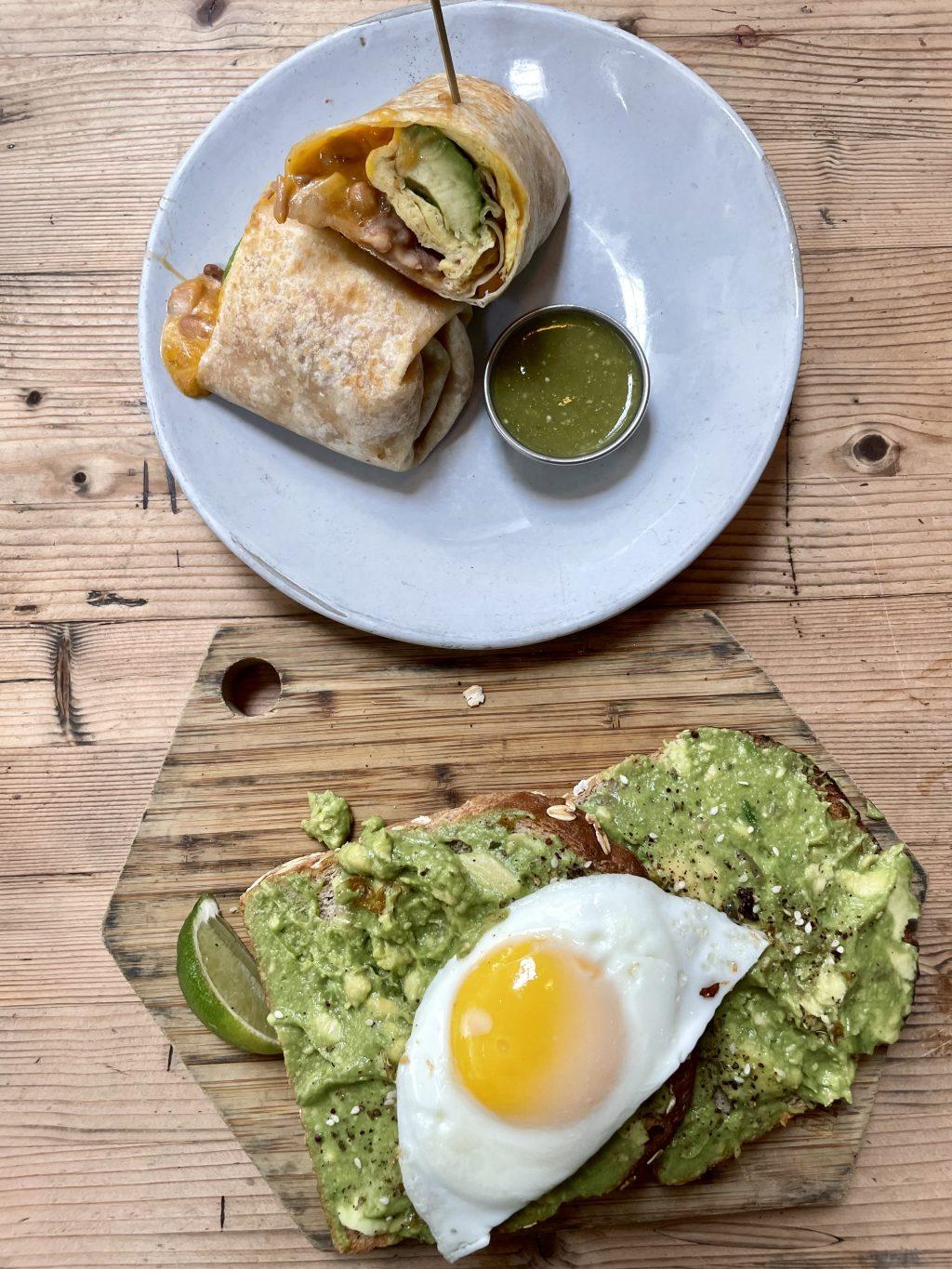 Two menu items from the Butcher's Daughter include avocado toast and their Surfer's Burrito with filling made from farm eggs, avocado, cheddar, pinto beans and hash browns. The café offered a selection of breakfast items that were available throughout the entire day.