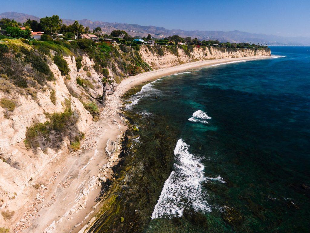 In Big Dume, the ocean pushes the beach back onto the cliffs in October. Without sand dunes, Martin said there is no natural sand replenishment, and artificial sand replenishment lasts a decade at best.
