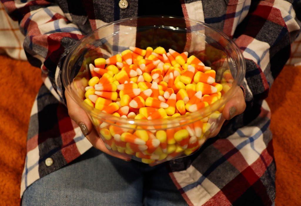 Senior Aubrey Henrie dons a flannel and enjoys some candy corn in her apartment.