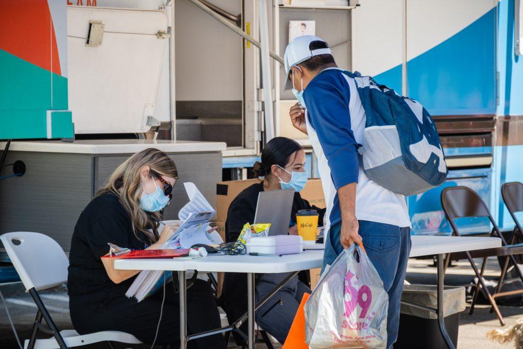 An attendee at the annual Malibu Homeless Connect Day on Sept. 22 approaches the Venice Family Clinic staff. The VFC improved the health of communities through accessible care since its founding in 1970. Photo by Lucian Himes