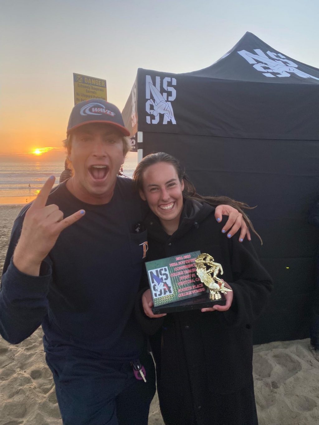 Sophomore Natalie Alderton (right) takes a picture with Head Coach Joseph Rickabaugh after the NSSA Ventura Harbor Contest on Nov. 7. Proodian said the team had known about each other before they met at Pepperdine because of all the surfing competitions they competed in while they were younger.