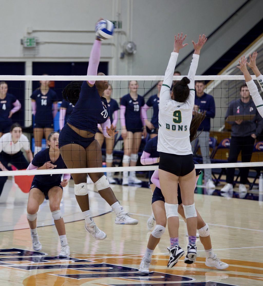 Freshman middle blocker Vanessa Polk (No. 20) goes up for a kill versus the Dons on Oct. 29 at Firestone Fieldhouse. The Waves' offensive struggles showed in the latter half of the game — only scoring totals of 22, 15 and 11 kills after a strong start to the game.