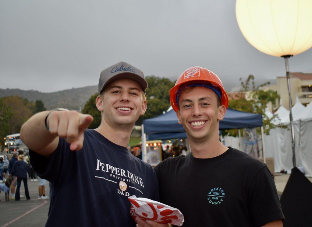 Asher Witham and Ethan Van Beek pose for a picture at Madness Village on Oct. 14. Students enjoyed a night with friends and family. Photo by Colton Rubsamen