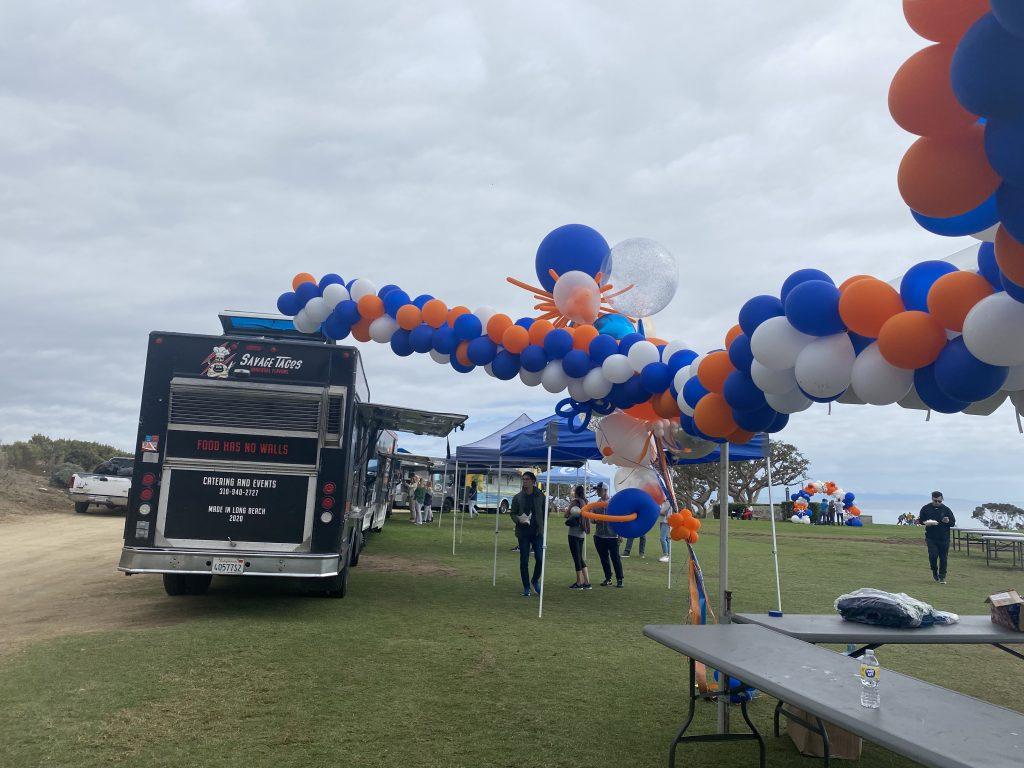 Food trucks serve lunch to students and their families on Alumni Park Oct. 15. Chairs, tables and umbrellas were provided. Photo by Tanya Yarian