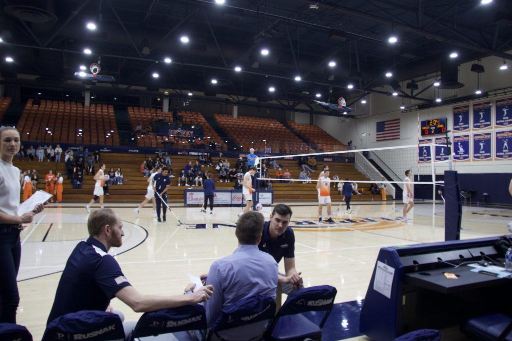 The Pepperdine Men's Volleyball coaching staff gathers around while the Waves prepare to play a set versus Emmanuel on Jan. 14. Winder was a former Pepperdine alumnus who graduated in 2008 and coached at Fresno State, according to Pepperdine Athletics.