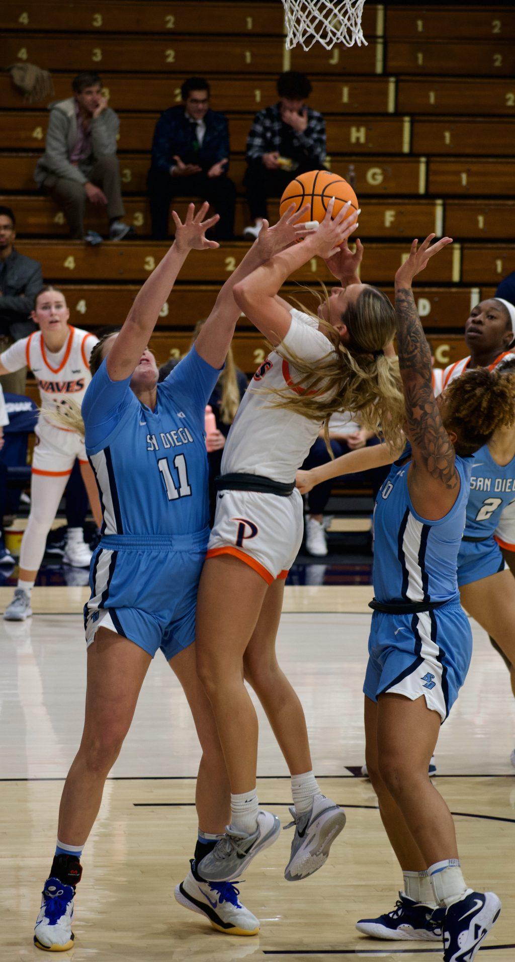 Pepperdine junior forward Jane Nwaba hits a jumper against a San Diego defender Jan. 12, at Firestone Fieldhouse. Nwaba finished the game with 10 points, six rebounds and an assist. Photos by Colton Rubsamen