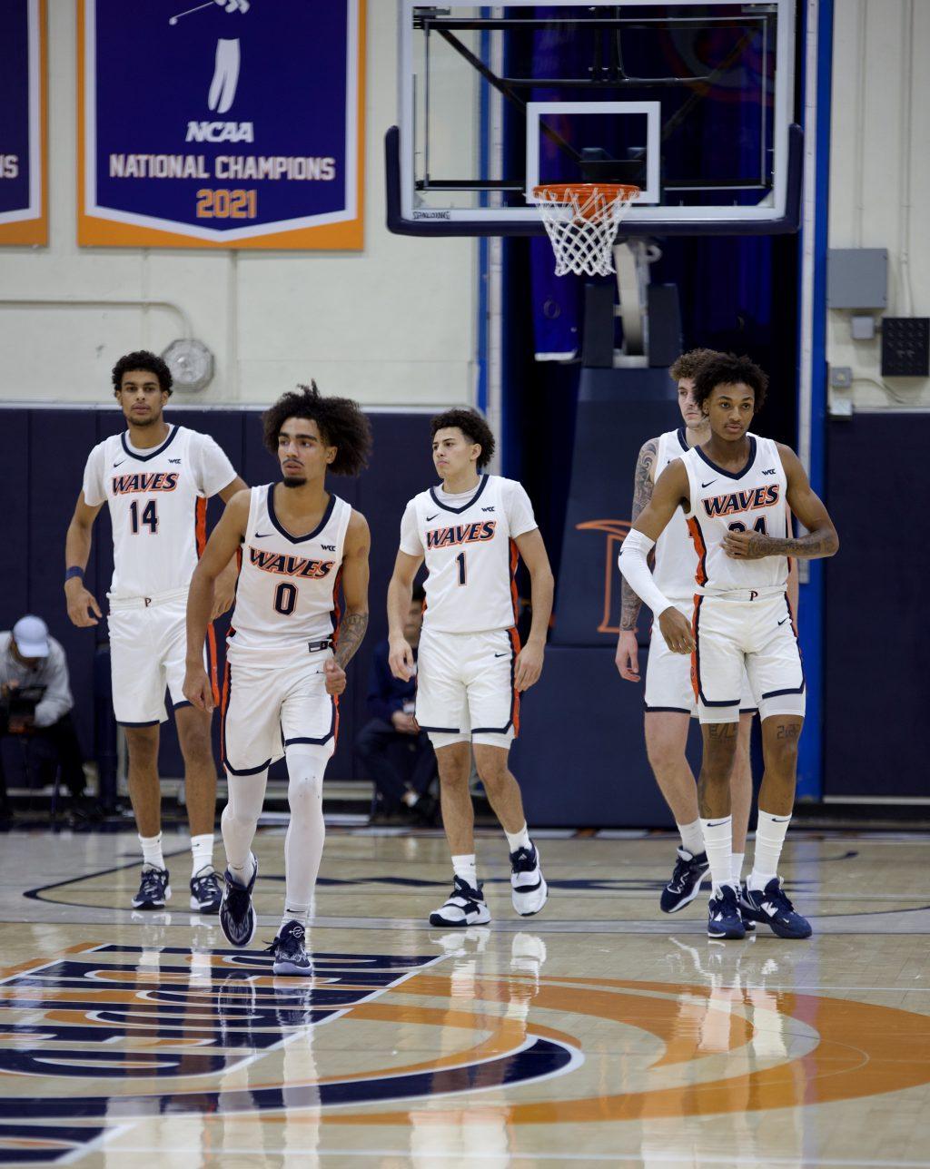 Pepperdine Men's Basketball starters trot on the court versus Rice University on Nov. 7 at Firestone Fieldhouse. Lewis said the Pepperdine coaching staff allowed him to make mistakes his first year, and he's sharper now.