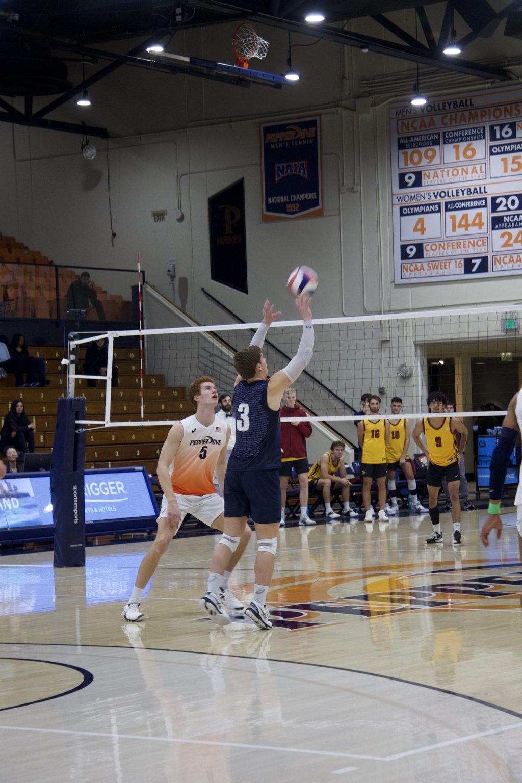 Junior libero Trey Cole sets up a teammate versus Emmanuel on Jan. 14 at Firestone Fieldhouse. Cole played in two sets and finished with five digs.