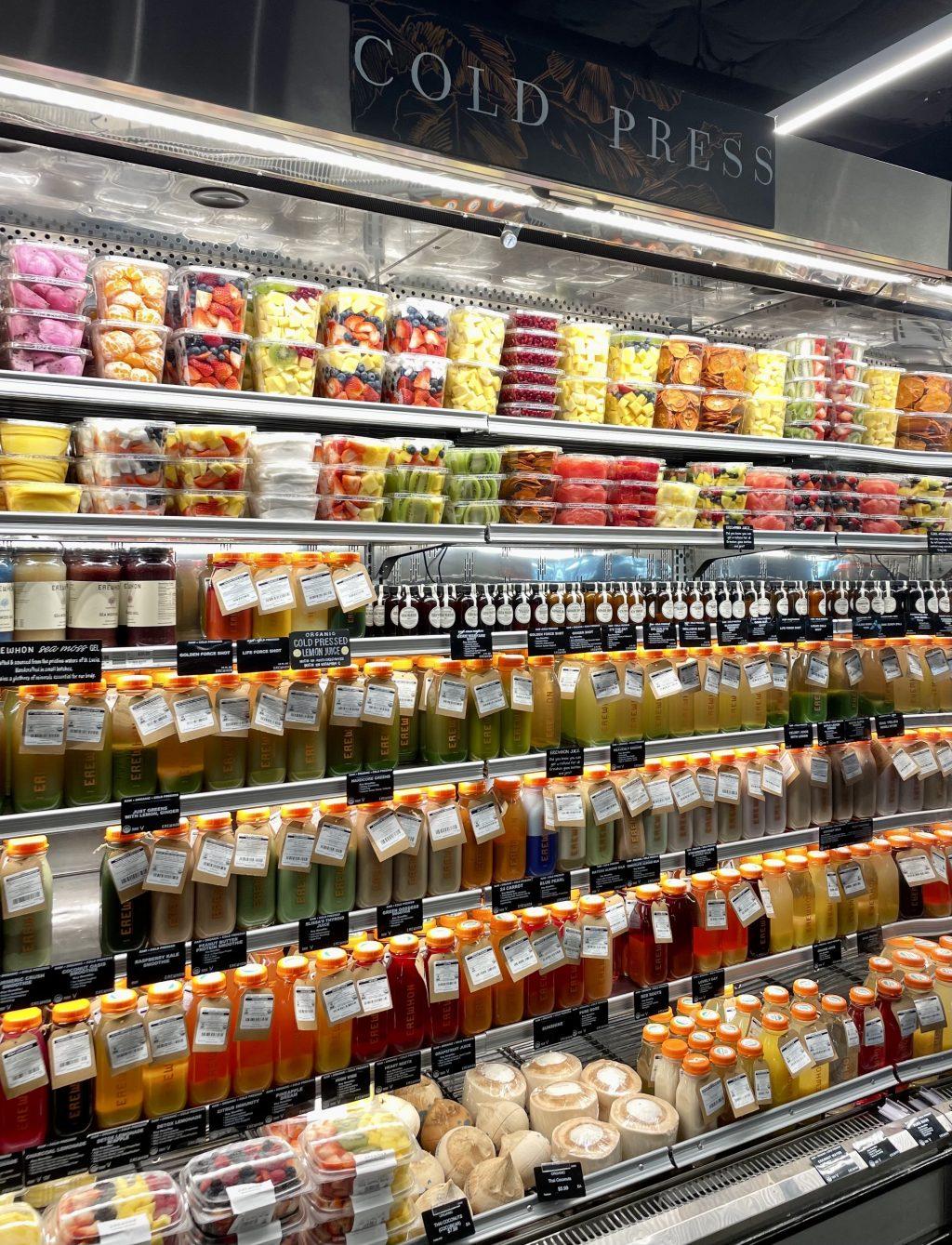 Erewhon's fully stocked cold case features a range of nutrient dense fresh pressed juices and smoothies as well as pre-cut fresh fruit.  The shop's freshly squeezed and fresh juices have become an internet sensation after being promoted by numerous online influencers, The New York Times reports.
