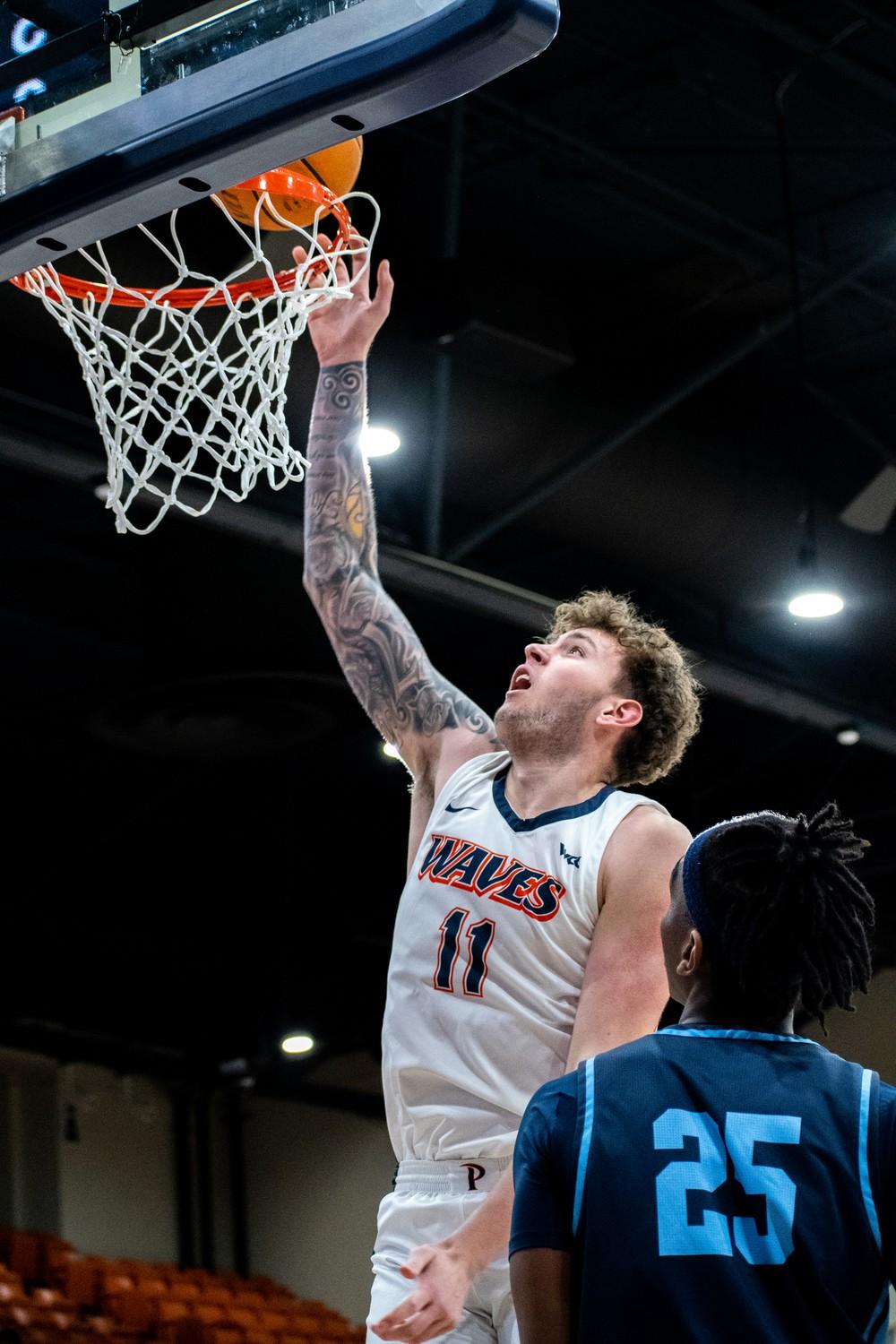 Sophomore center Carson Basham goes up for a layup in a 87-76 loss to San Diego on Jan 24. Basham scored a career-high 18 points in the game.