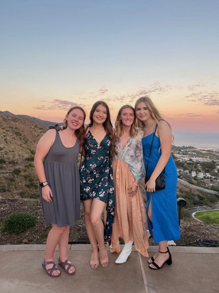 Bretzius, Bryant, Donovan and Henrie pose in front of a scenic view in Malibu at sunset. The four girls attended the "Rock the Brock" event at President Jim Gash&squot;s house together at the start of their senior year. Photo courtesy of Katie Donovan