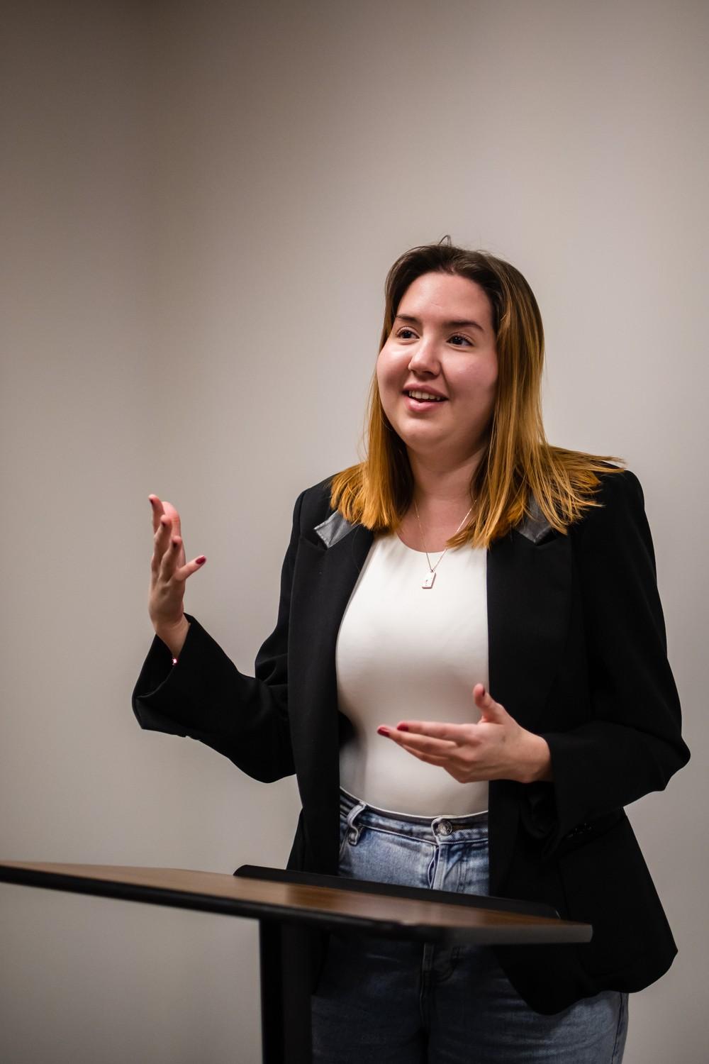 Leyla Pisirici poses behind a podium while re-enacting her debate skills in January. Pisirici was a finalist in the country her first year on the team and has now debated for three years. Photo by Lucian Himes