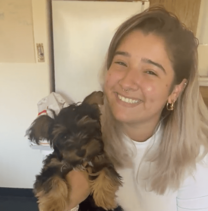 Senior Isabella Figueres poses with her emotional support animal Matcha in Drescher housing in September 2022. Figueres said Matcha's cuddles help with her anxiety. Photo by Kiera Hennigan