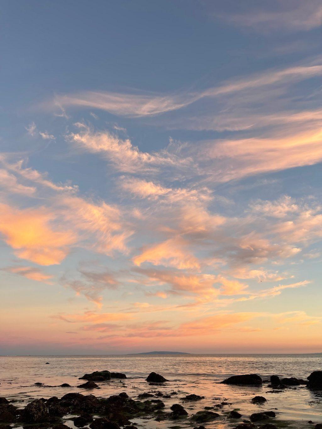 Light orange 'wispy boys' float across the sunsetting sky over the rocky shoreline of Puerco Beach in Malibu on Nov. 11. After deciding homework could wait a little longer, I hopped into my car and rushed over to spend some alone time to reset and admire the sky. Photos by Lisette Isiordia