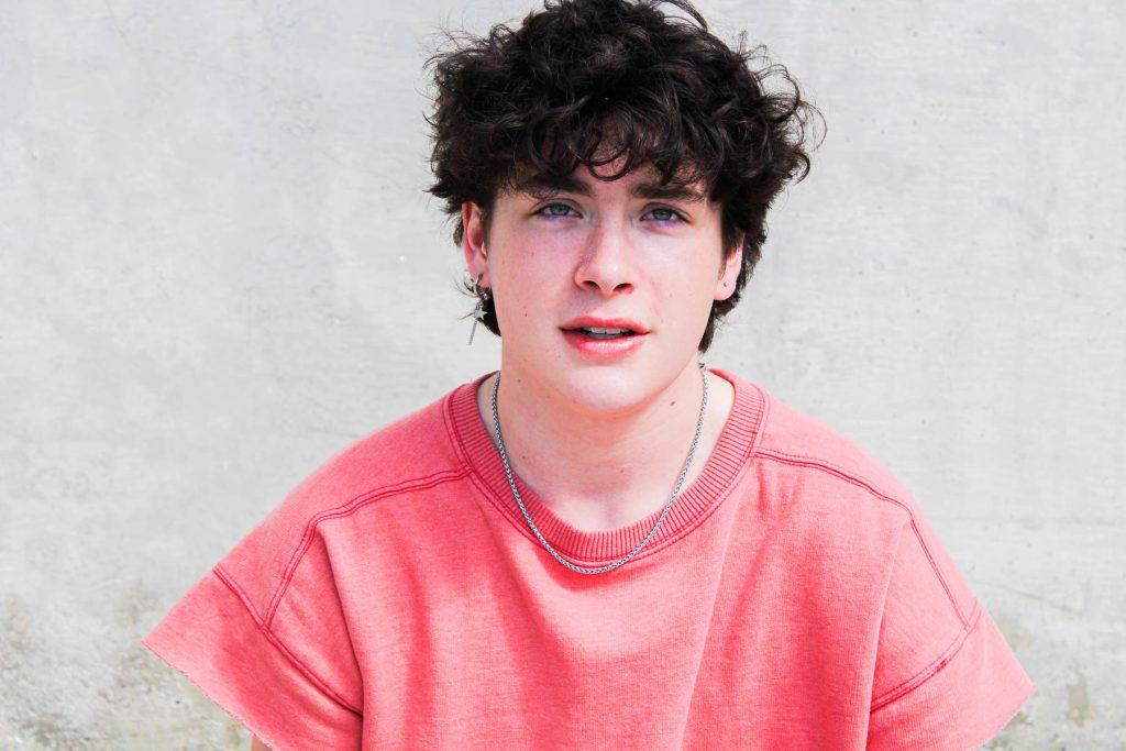 First-year psychology major Ryan Pope, who identifies as a bisexual man, poses at Miller Town square. Pope’s exploration of his sexuality has caused questions and struggles within his own faith (Photo courtesy William Koning).