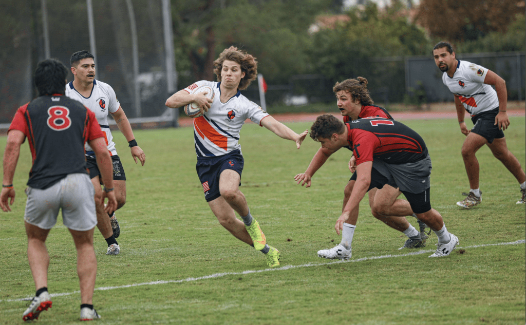 Senior Gideon Lee dodges the Azusa Pacific defense during a friendly match against Azusa Pacific University in Azusa, Calif., on Oct. 15. Lee is a captain and the president of the rugby team.