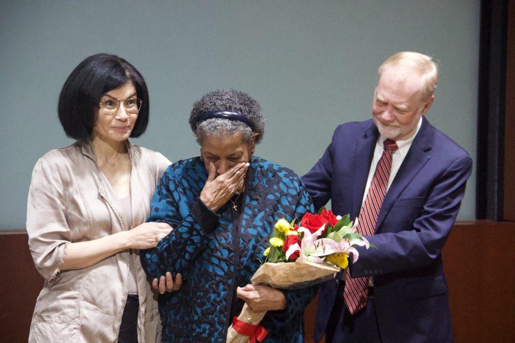 Jami Floyd, Myrlie Evers and Jerry Mitchell stand at the front of Elkins Auditorium on March 16. The crowd sang Myrlie happy birthday.