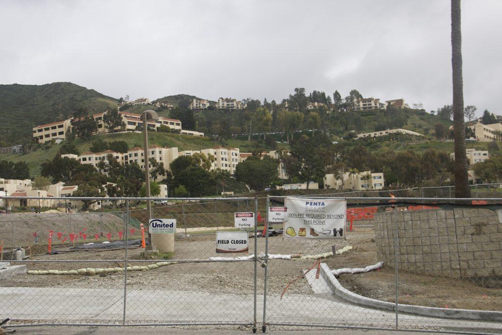 A fence blocks the construction site of the Enhanced Parking and Storage Project by the baseball field March 16. The University hoped to finish construction on the project by August 2021, but COVID-19 delayed it, according to previous Graphic reporting.