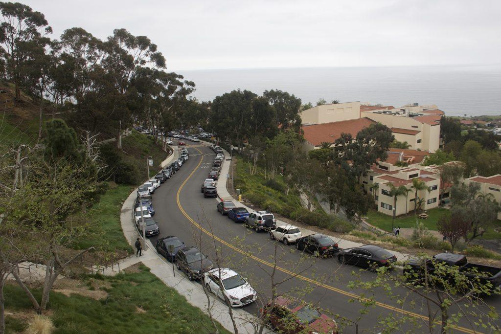 Cars park bumper to bumper along Seaver Drive on March 16. Sophomore Elizabeth Robison said the lack of parking is due to construction on campus and the enrollment of a large first-year class.
