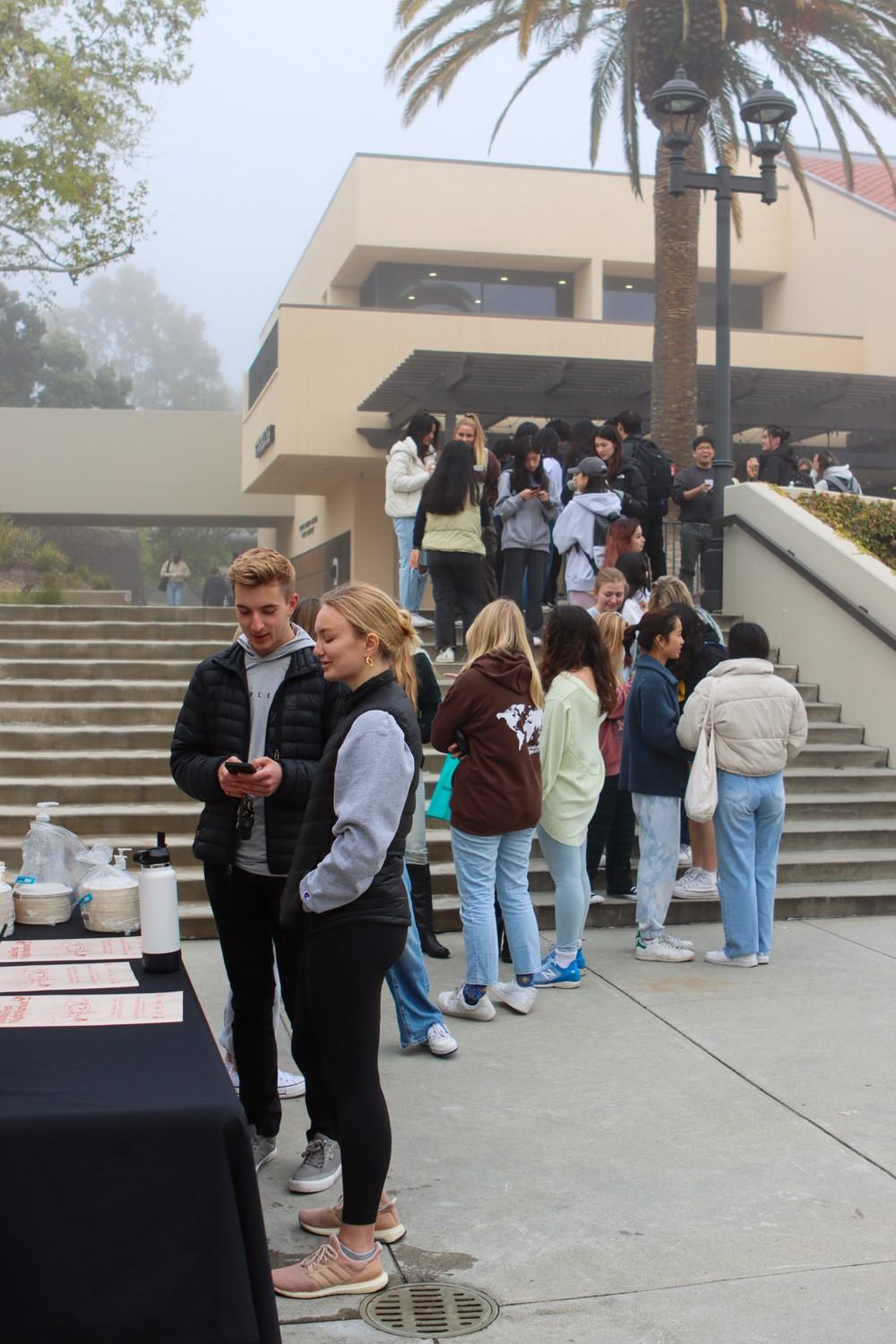 Students wait in line to check into the Global Fest Night Market by scanning a QR code on the CampusGroups website on March 11. Students who attended the Night Market had the opportunity to enter a raffle for Pepperdine-themed merchandise, Mella said.