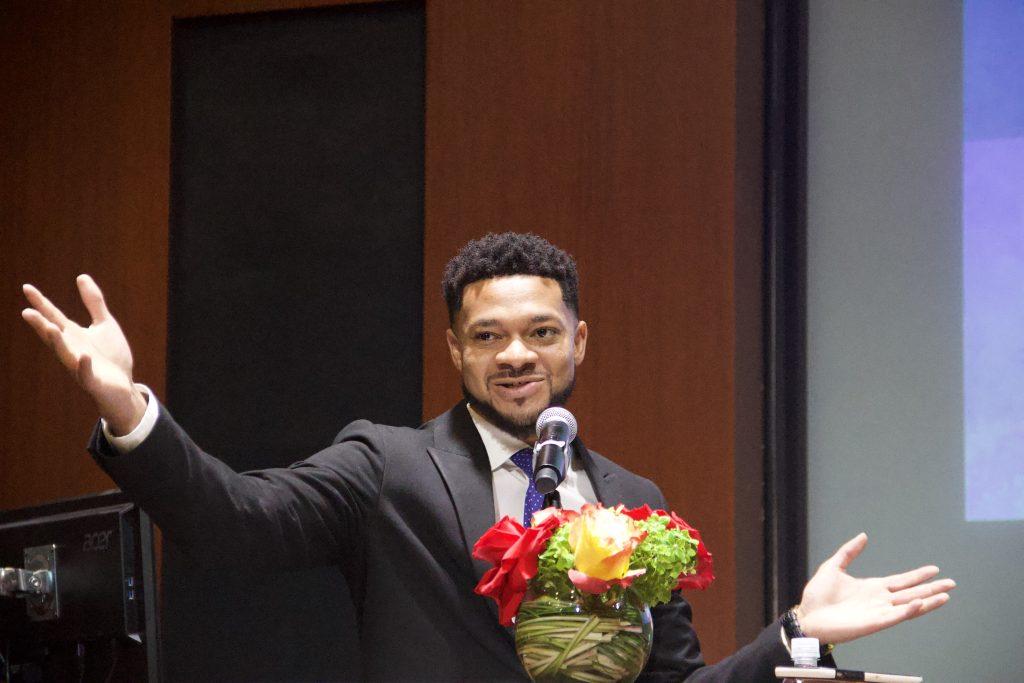 Stanley Talbert gestures to the audience in Elkins Auditorium on March 16. Talbert was the first to speak at the event.