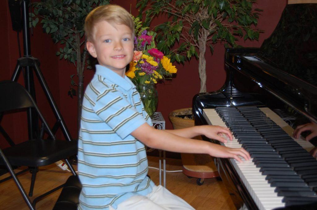 Junior Joseph Sadler plays his childhood piano in 2009 in Colorado. Sadler said growing up, his parents would play a lot of classic rock, musical theater and classical music. Photo courtesy of Joseph Sadler