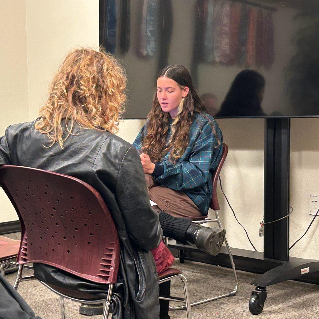 Senior Annabella Nordlund performs her poem, "The Tile," in the Intercultural Affairs Lounge on March 13. Nordlund said it was good to step out of her comfort zone and share something.