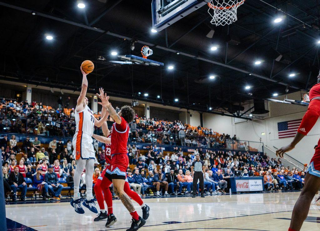 Sophomore center Carson Basham shoots a floater versus LMU on Feb. 23, at Firestone Fieldhouse. The Waves shot 45% from the field.