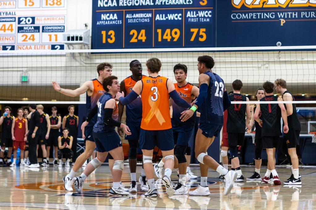 Pepperdine Men's Volleyball team huddles after a score versus USC on March 9, at Firestone Fieldhouse. The Waves stayed ahead of the Trojans and won 3-0.