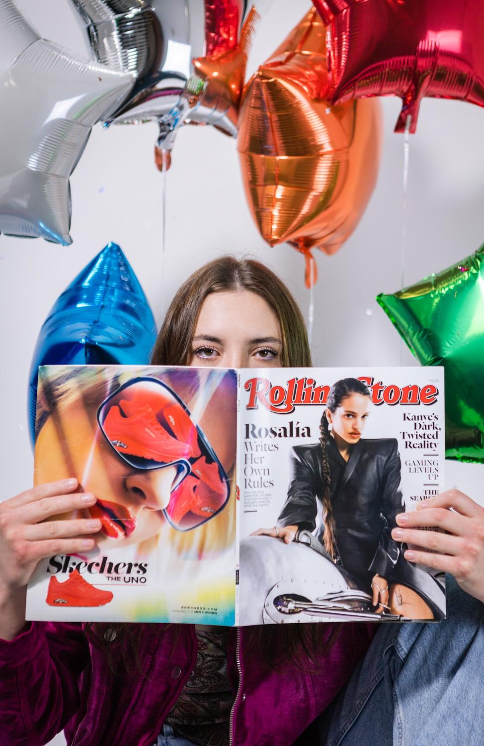 Wishard peeks over her Rolling Stone magazine.