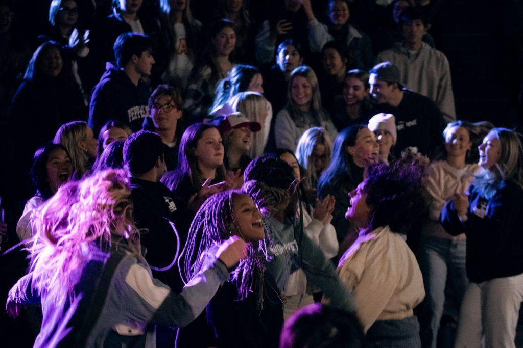 Attendees of The Well dance and sing to a worship song Feb. 16, in the Amphitheatre. The Well embraces worship through song, according to their Instagram page.