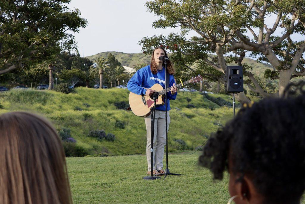 Nick Barron sings during Coffeehouse at Senior Sunset on Alumni Park on April 7. The Board combined Senior Sunset with Senior Coffeehouse.