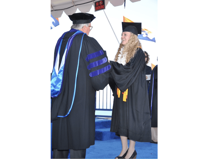 Falon Barton (right), alumna ‘15 shakes hands with then President Andrew K. Benton (left) to receive her diploma. Barton graduated early with degrees in journalism and Hispanic studies in May 2015 (Photo courtesy of Falon Barton).
