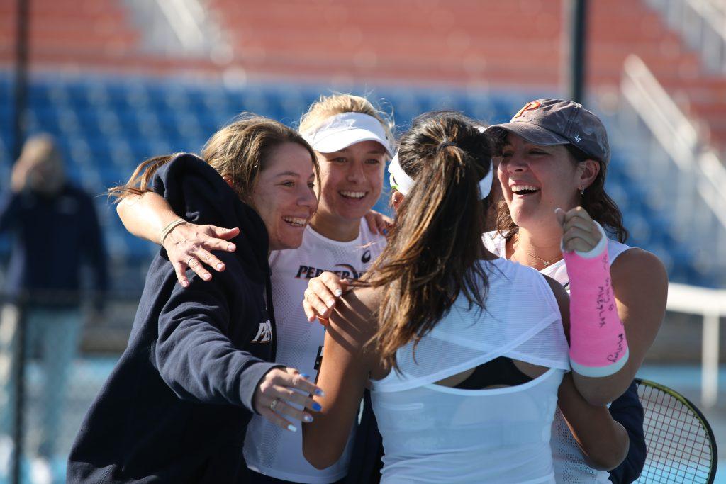 The Waves celebrate their win against No. 5 Michigan at the Ralphs-Straus Tennis Center on March 4. The No. 9 Waves swept Michigan 4-0 in the top-10 matchup. Photo by Pepperdine Athletics