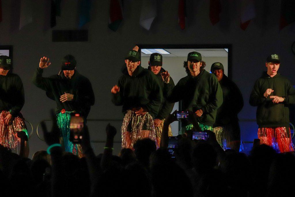 Alpha Tao Omega members smile as they perform on stage March 31, at the Caf. The audience cheered when they came out to perform.