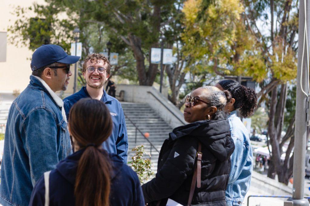 Carter Lentz, senior and tour guide, speaks to a tour group outside the Amphitheatre on March 31. Lexi Aguayo, associate director of Admission, said this year had the second highest amount of applications in the school's history.