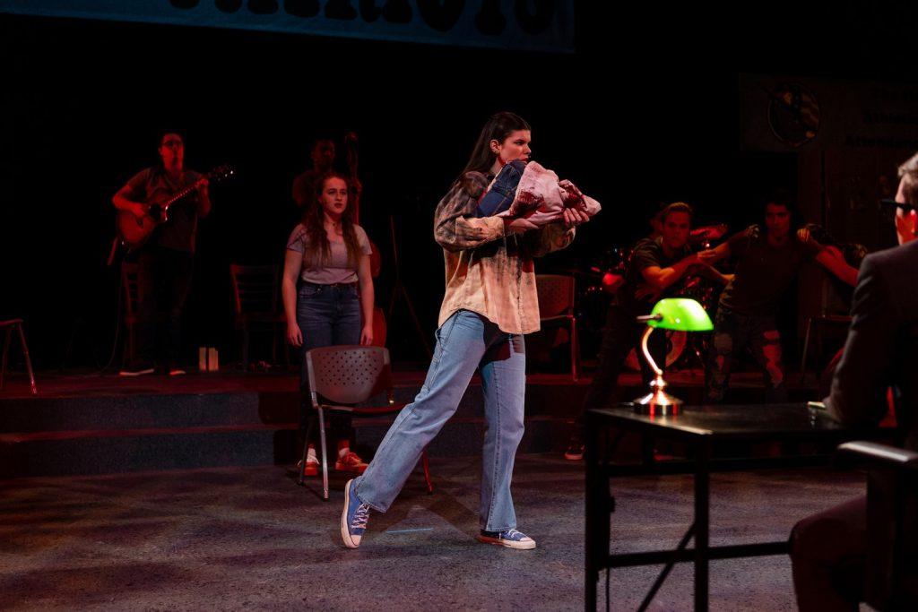 Kayla Bryant, who played Number 1/Pearl, stands on stage after having a nightmare of being the school shooter in Smothers Theatre on April 3. The play challenges the stereotypical profile of a school shooter as Pearl says in the play, "It&squot;s never a girl."