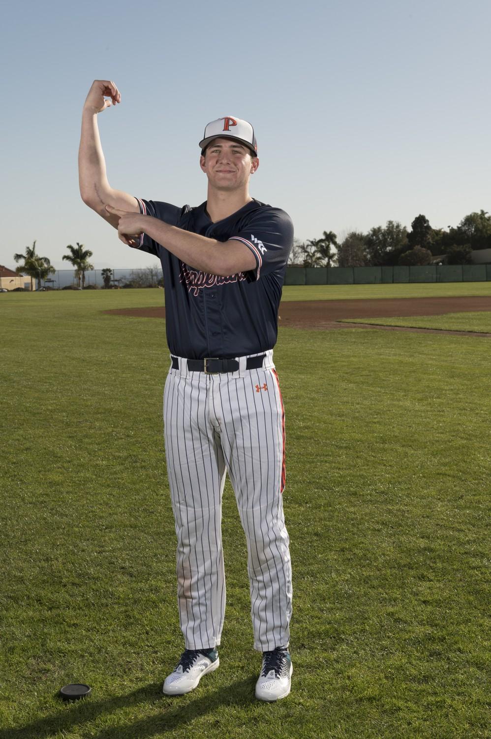 Baseball first-year pitcher Adam Troy shows his scar from Tommy John surgery. Since then, Troy said he has dedicated his time to recovering and healing his ligament.