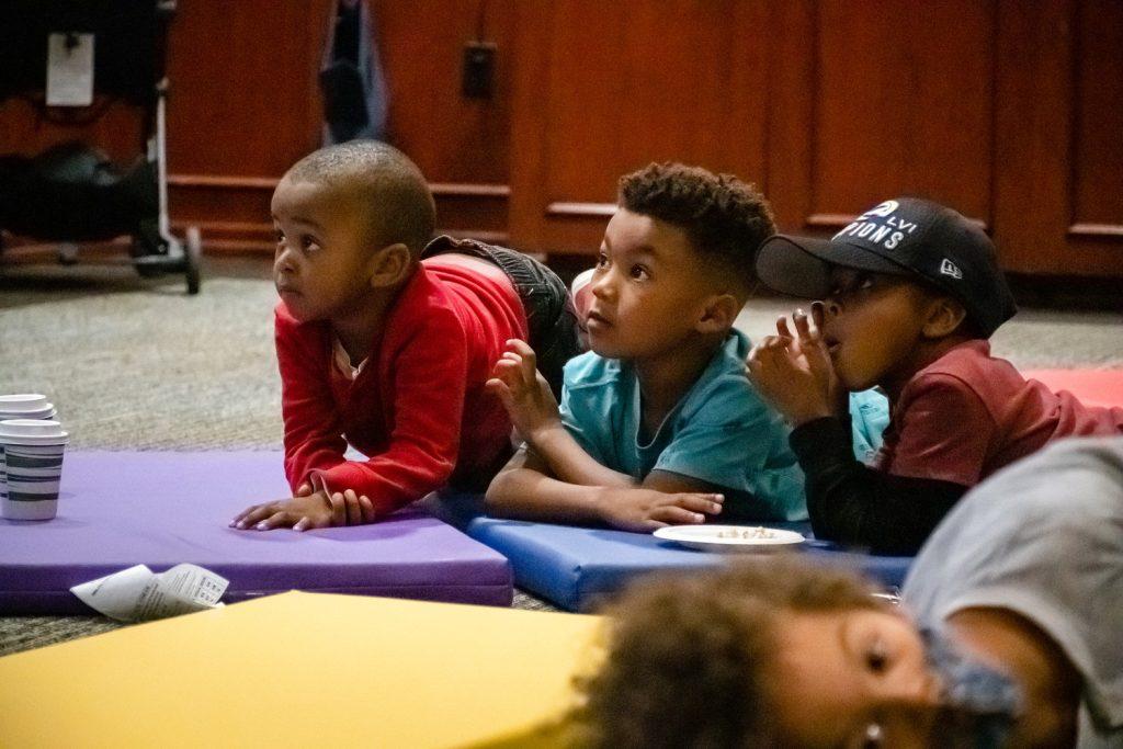 Children watch Singleton as he reads his children's books during Story Time on March 13. Singleton published his first children's book in 2020.