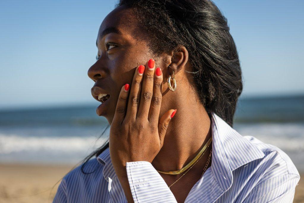 Deslyn Williams soaks up the sun on the beach. Williams said she always applies sunscreen when going outside.