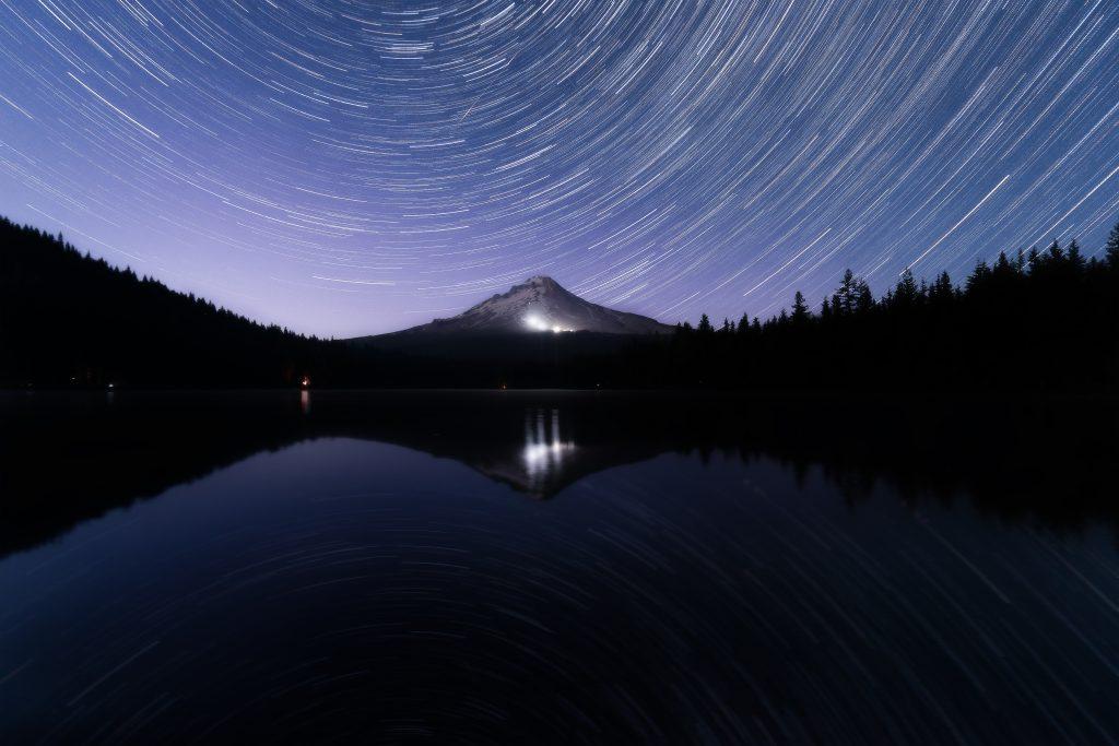 The stars spiral around the north star above Mt. Hood, Oregon, on July 25, 2020. The windless night allowed the stars to reflect in the still waters of Trillium Lake.