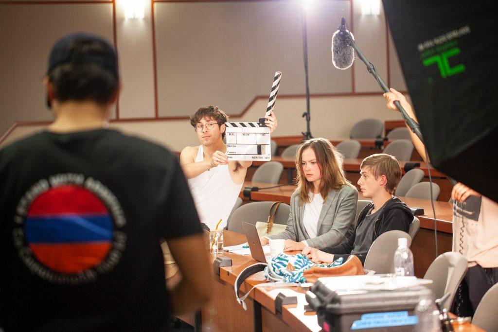 Sophomore Lorenzo Mars holds a clapperboard on set. Mars said he has a passion for storytelling and hopes to become a screenwriter one day. Photo courtesy of Lorenzo Mars