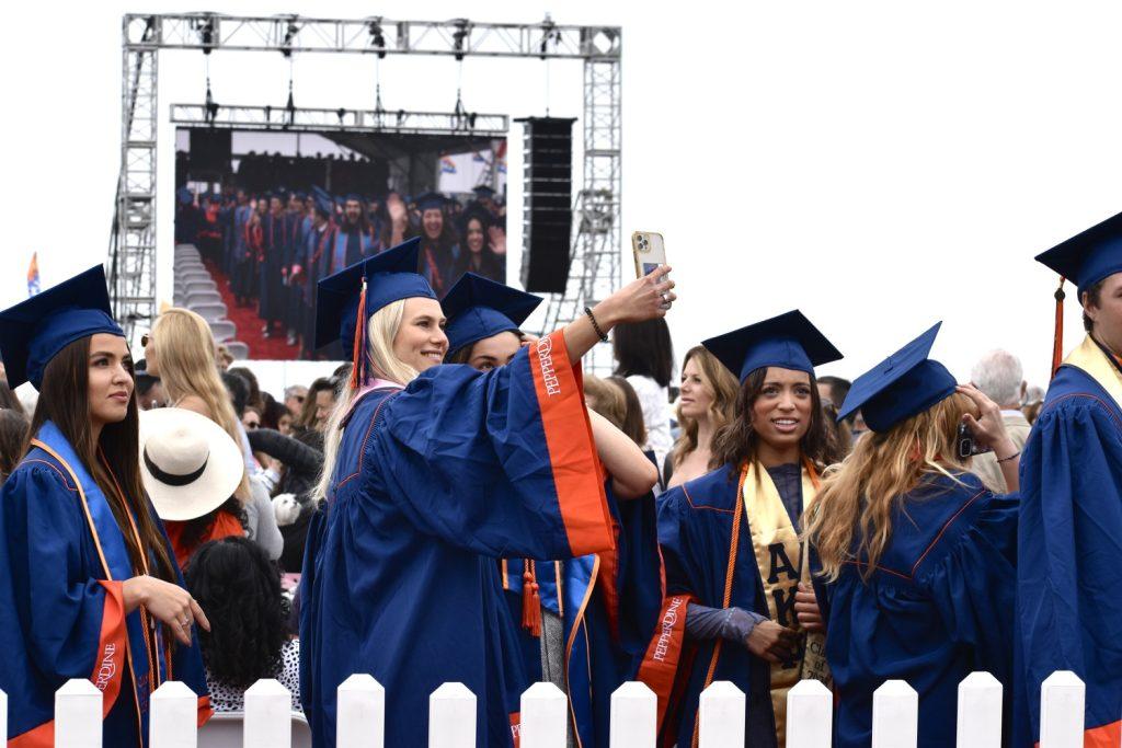 Seaver graduates pose for a selfie as they wait in line to receive their diploma. Many students took to social media to celebrate their achievements.