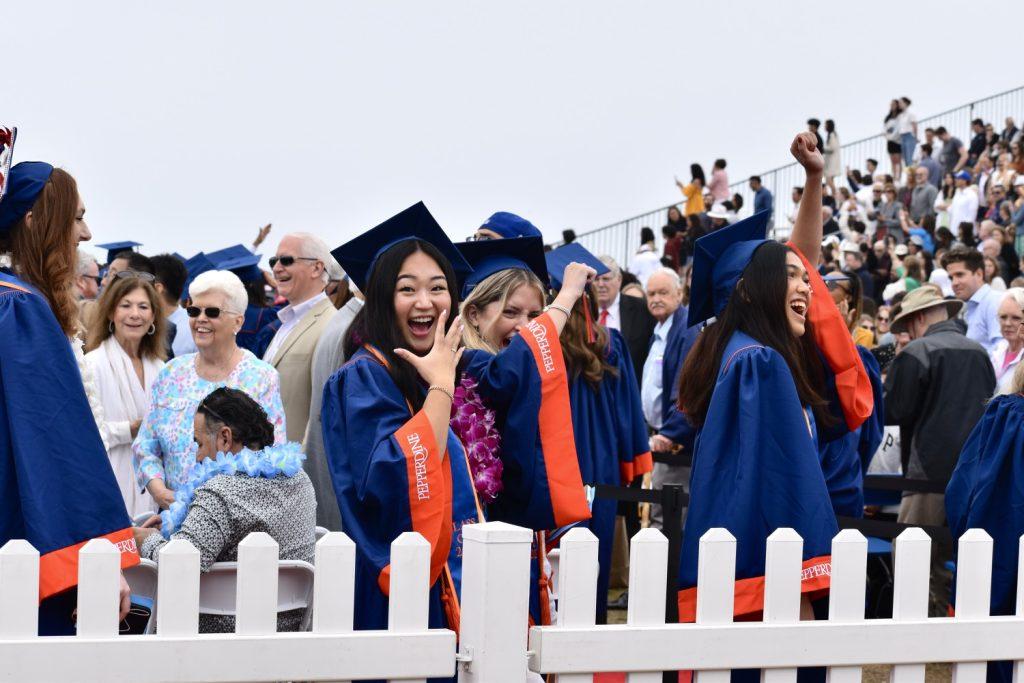 Graduate Sabrina Kuo smiles in excitement as she walks to receive her diploma. Kuo graduated with a Bachelor of Arts in Integrated Marketing Communications.