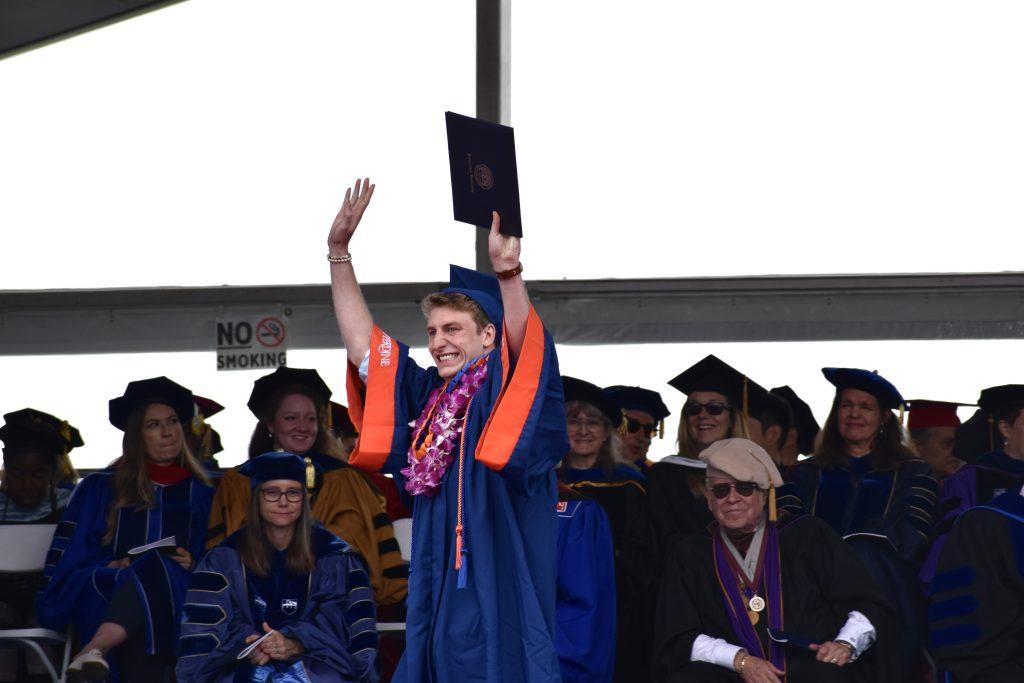Seaver College graduate Jon Samson waves excitedly to the crowd after receiving his diploma at Alumni Park on April 29. The commencement ceremony was live-streamed for anyone who wished to join in on the celebration. Photos by Mary Elisabeth