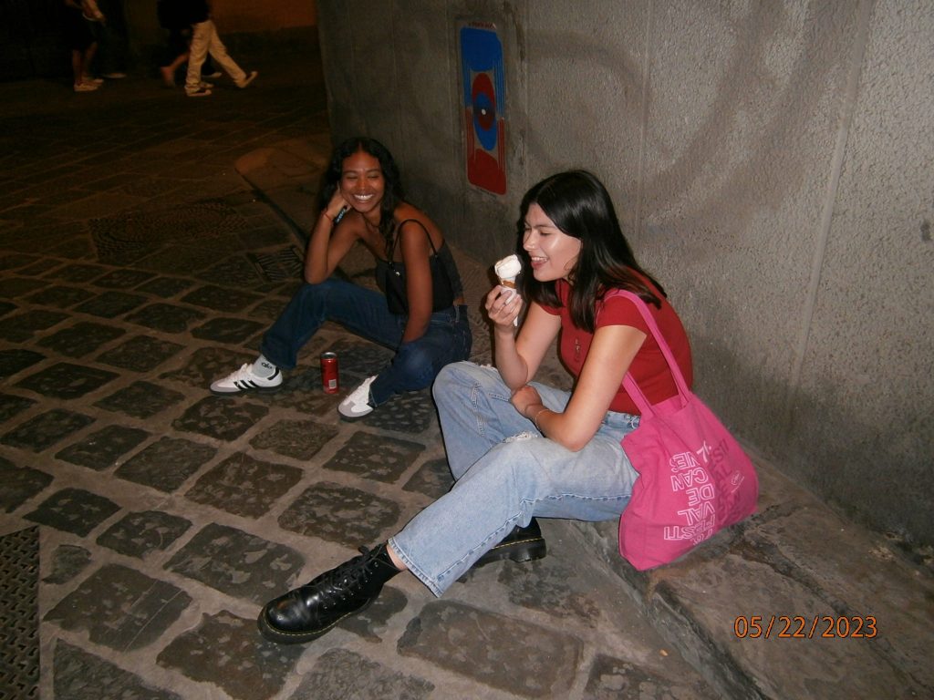 Junior Jordan Paran (left) and senior Emma Ibarra (right) eat gelato while sitting in the streets of Florence. Gelato has been an Italian specialty since its creation in the 16th century.