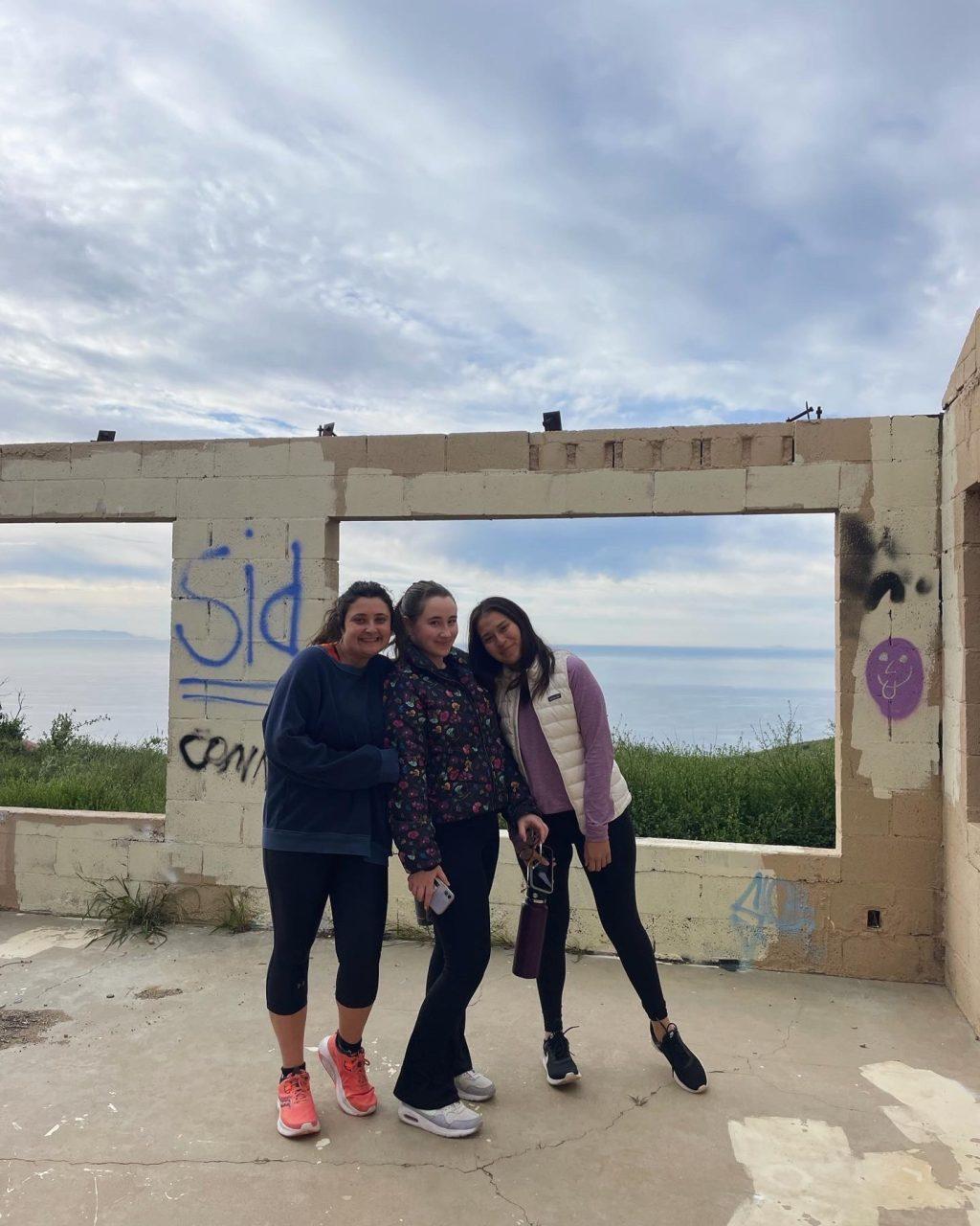 Lead Designer Skyler Hawkins (middle) and former designer Lisette Isiordia ('23) (right) and I posing (left) while on a hike in Malibu in February. Hikes with friends have been some of my top Pepperdine memories.