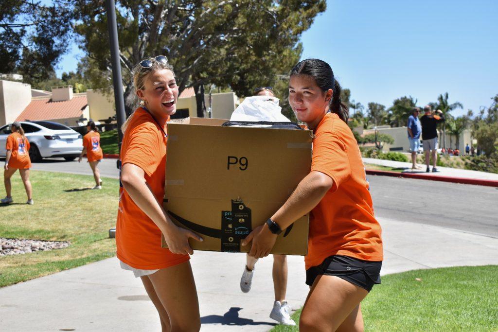 NSO leaders, junior Lindsay Hall (left) and Aisha Arango Robayo (right), moving in boxes to first-year dorms Aug. 15. First-year students moved in throughout Monday and Tuesday of NSO week.