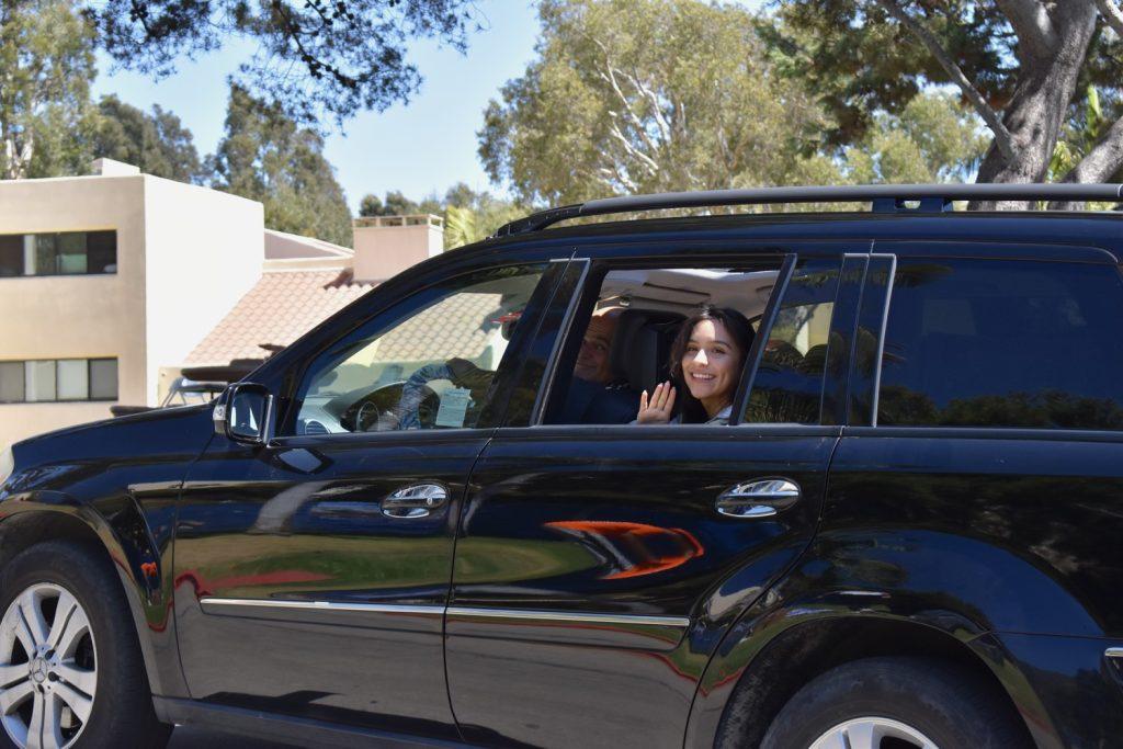 First-year student waving and smiling Aug. 15. First-year students drove close to their dorms to unpack their cars.