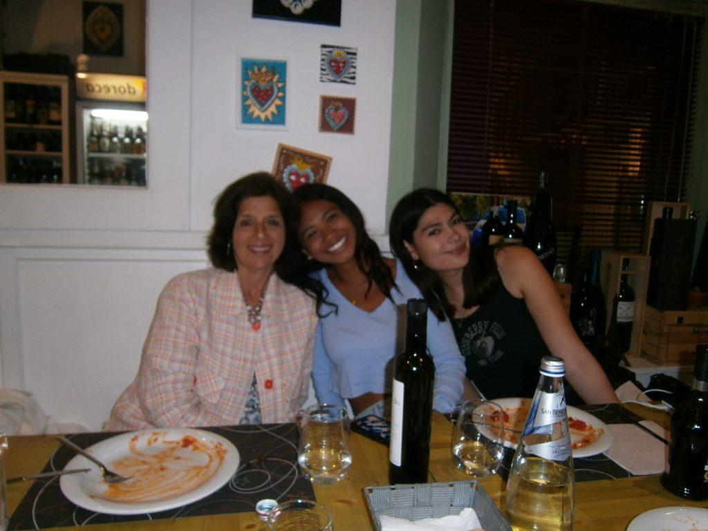 Florence program director, Elizabeth Whatley (left), poses with junior Jordan Paran (middle) and senior Emma Ibarra (right), after eating pasta at a program dinner. During the first week of the two-month Florence GE program, students ate together at a variety of local restaurants to try traditional Italian cuisine.